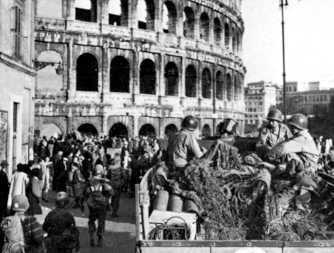 A convoy of American troops passes the Coliseum in Rome after the city was liberated on June 4, 1944.