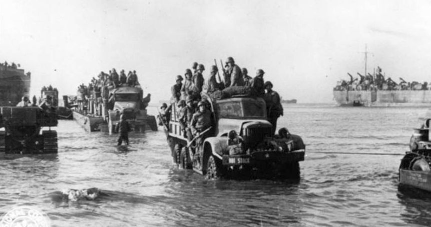 Troops and equipment come ashore at Anzio. National Archives.