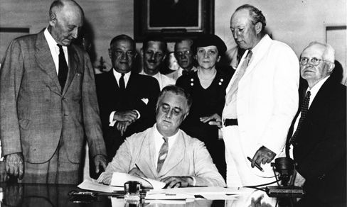 Contrary to popular belief, FDR had little to do with the passage of the Social Security Act of 1935, other than having appointed Frances Perkins, who stood behind him at the signing of the bill. FDR Library