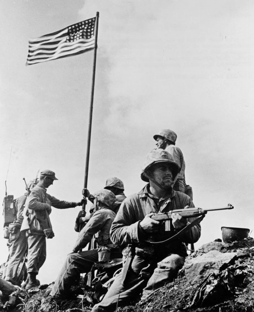 Staff Sgt. Louis R. Lowery photographed the first flag on Mount Suribachi. National Archives.