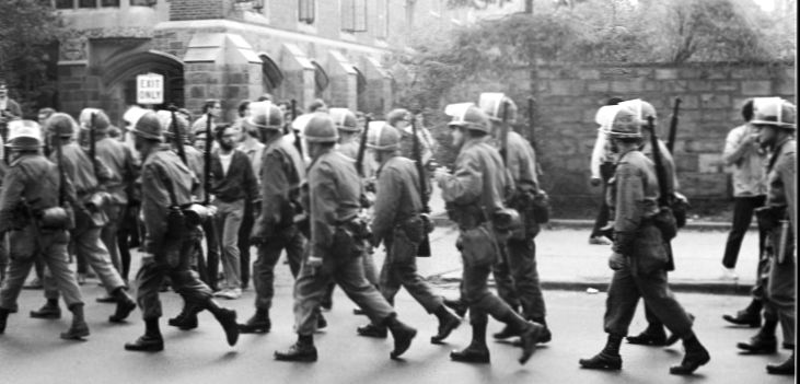 National Guard troops march in front of the Yale newspaper office on their way to quelling demonstrations on the New Haven Green. Tom Strong.