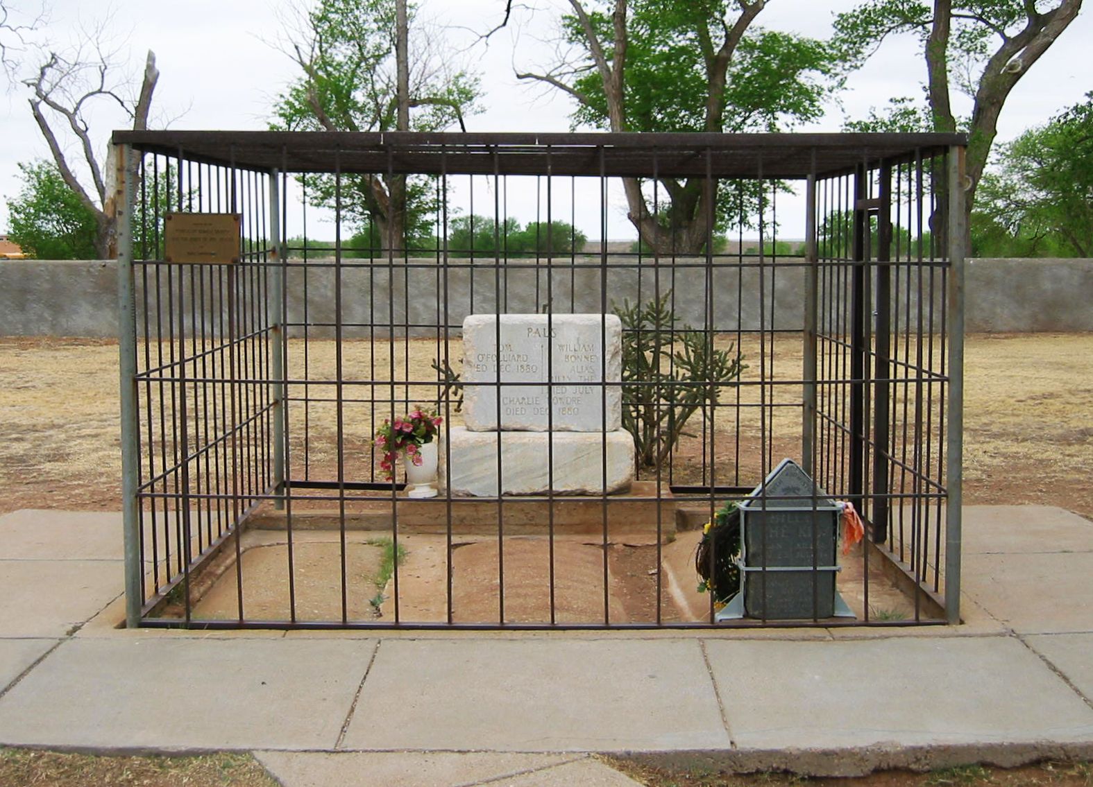 Finally caged in death: Billy the Kid is reportedly buried under a tombstone at the Old Fort Sumner Cemetery is enclosed behind iron bars to prevent it being stolen for a third time.  Photo by Sam Vast.