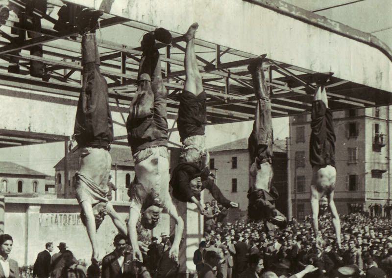 The dead body of Benito Mussolini (second from left) hangs next to his mistress Claretta Petacci and those of other executed fascists in Milan on April 29, 1945.
