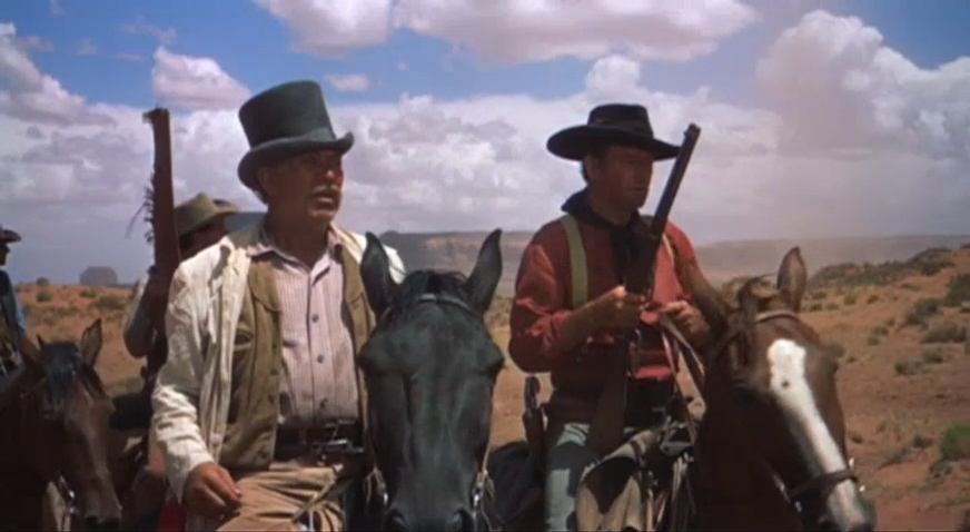 "I figure on gettin' myself un-surrounded," insists Captain Clayton (Ward Bond) to Ethan (John Wayne) as they realize they are caught in a trap and must run for their lives.