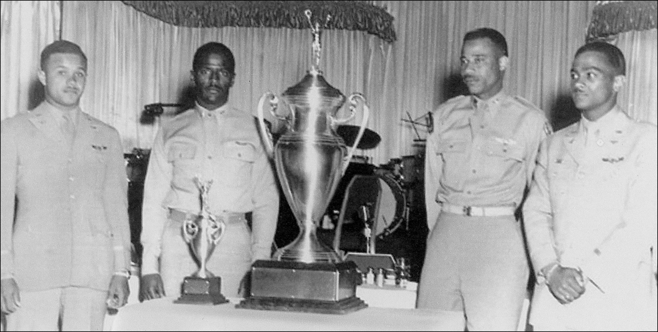 Stewart (right) and three other Tuskegee airmen pose with their trophy after winning the first Top Gun competition.