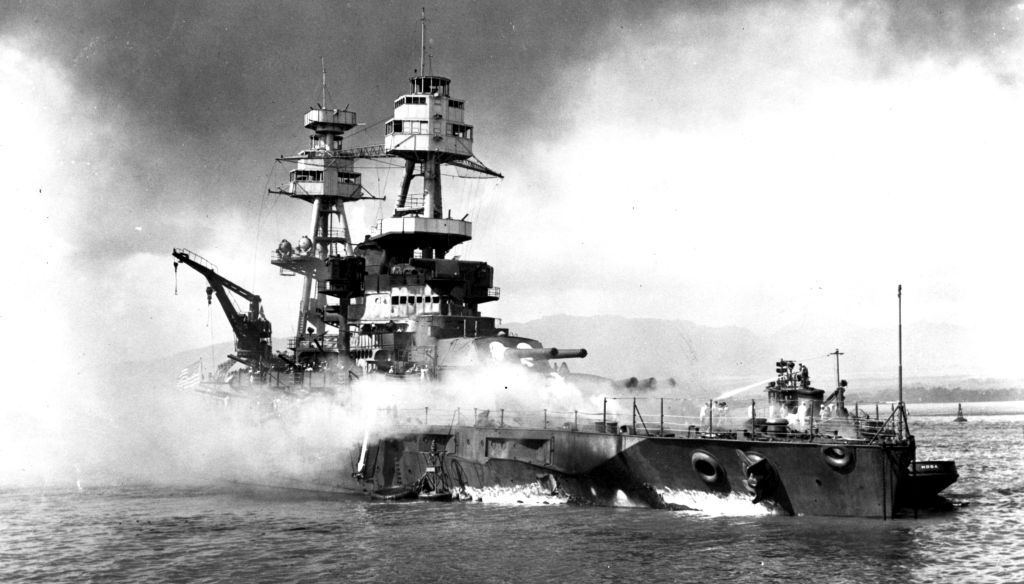 Thanks to the proactive planning of a young naval officer and the quick thinking of the crew, the USS Nevada was the only battleship to get underway at Pearl Harbor on the morning of December 7, 1941. But the Japanese planes swarming overhead focused their attack on her and she sustained heavy damage – including a 45 feet long and 30 feet high hole blown in her side by a torpedo. She was intentionally beached on Wapio Point, then repaired and returned to active duty.