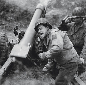 Artillerymen fire a howitzer using PCS firing charts