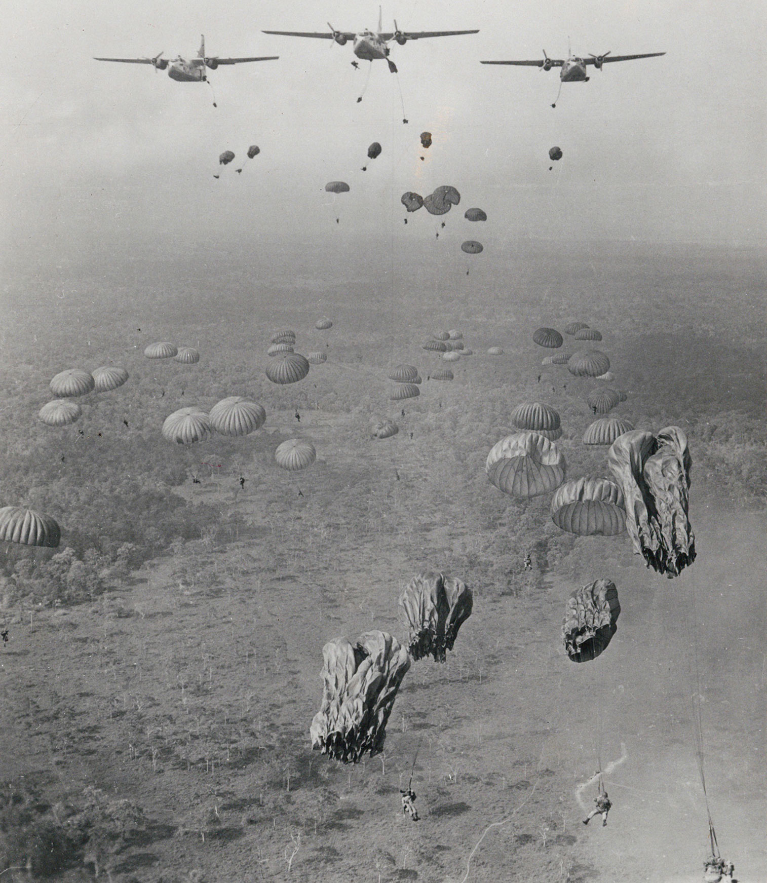 Leroy photographed American paratroopers descending to the ground while she herself swung back and forth under an Army parachute. 