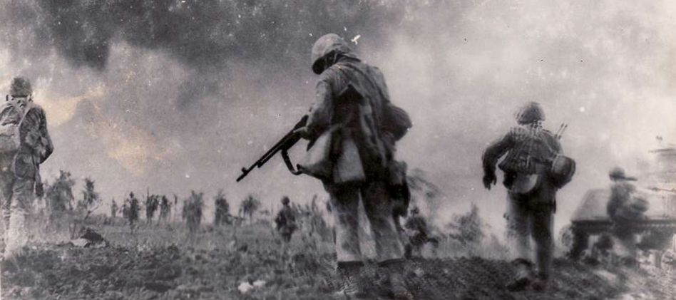 1st Division Marines move out for another assault near Wana Draw in the Okinawan mud. S Paridon.