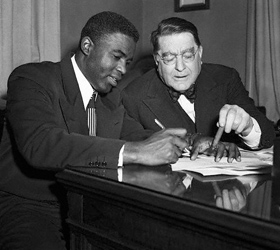 Robinson signs a contract with Rickey in 1950.