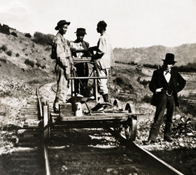 Three Chinese laborers work on a railroad in California around the 1890s.