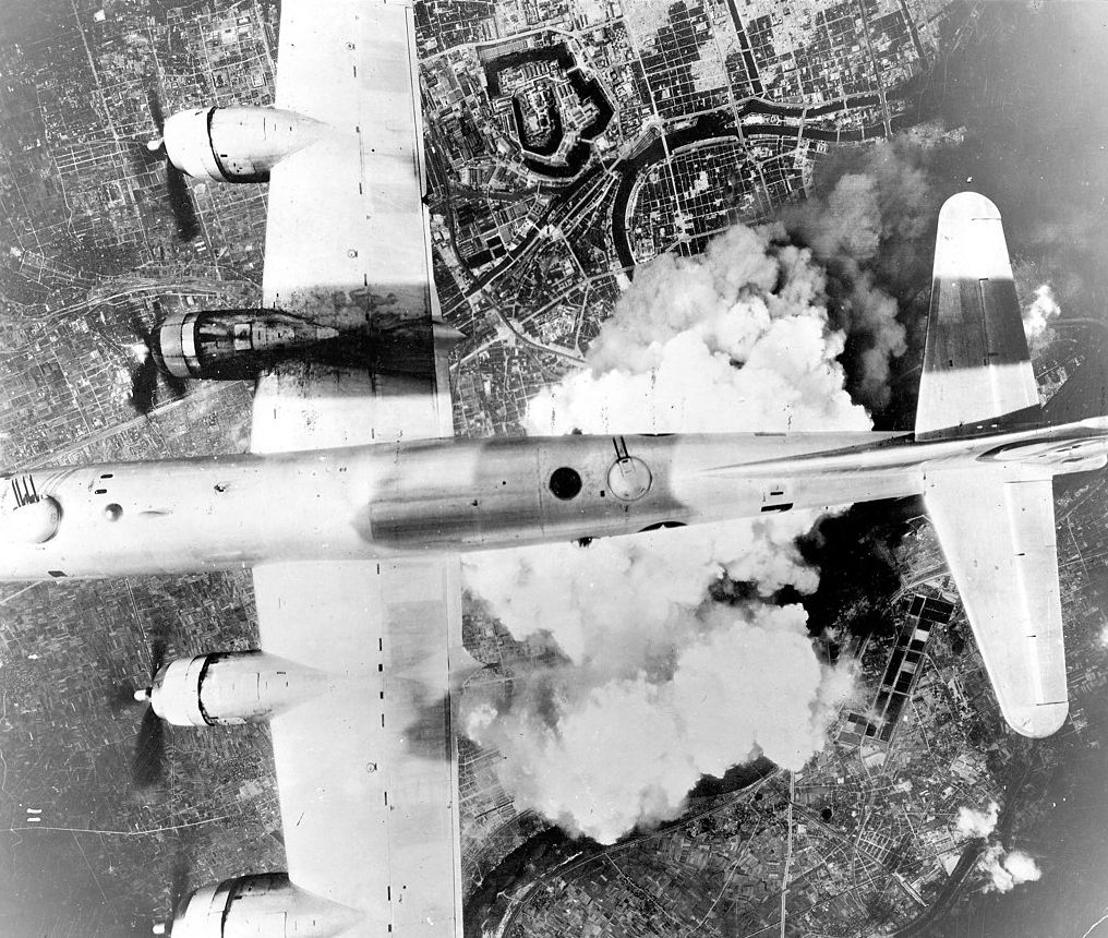 A B-29 Superfortress drops its incendiary bombs on Osaka.
