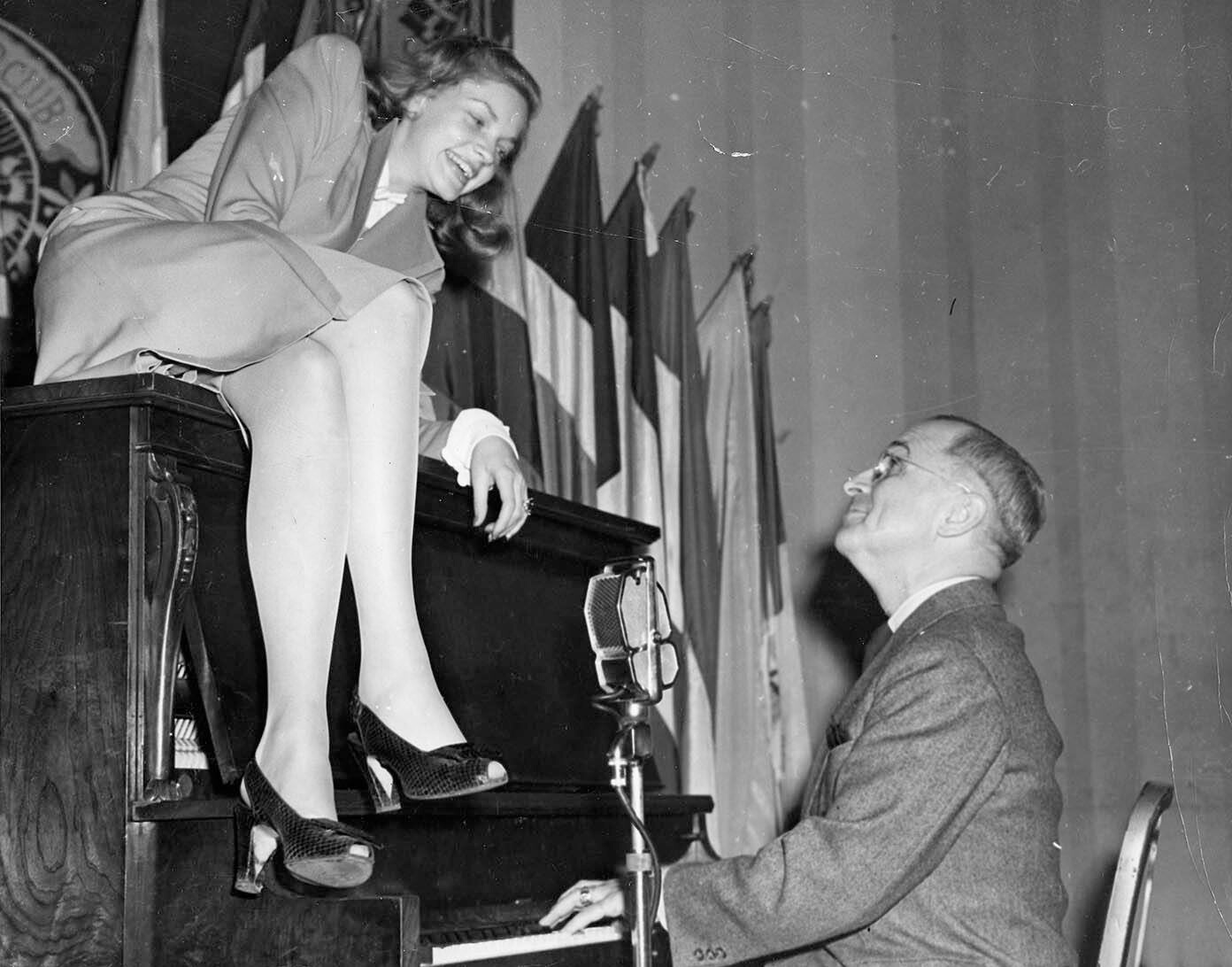 Harry Truman was just three weeks into his vice presidency when he was photographed playing the piano, looking up at Lauren Bacall whose shapely legs hang over the front.