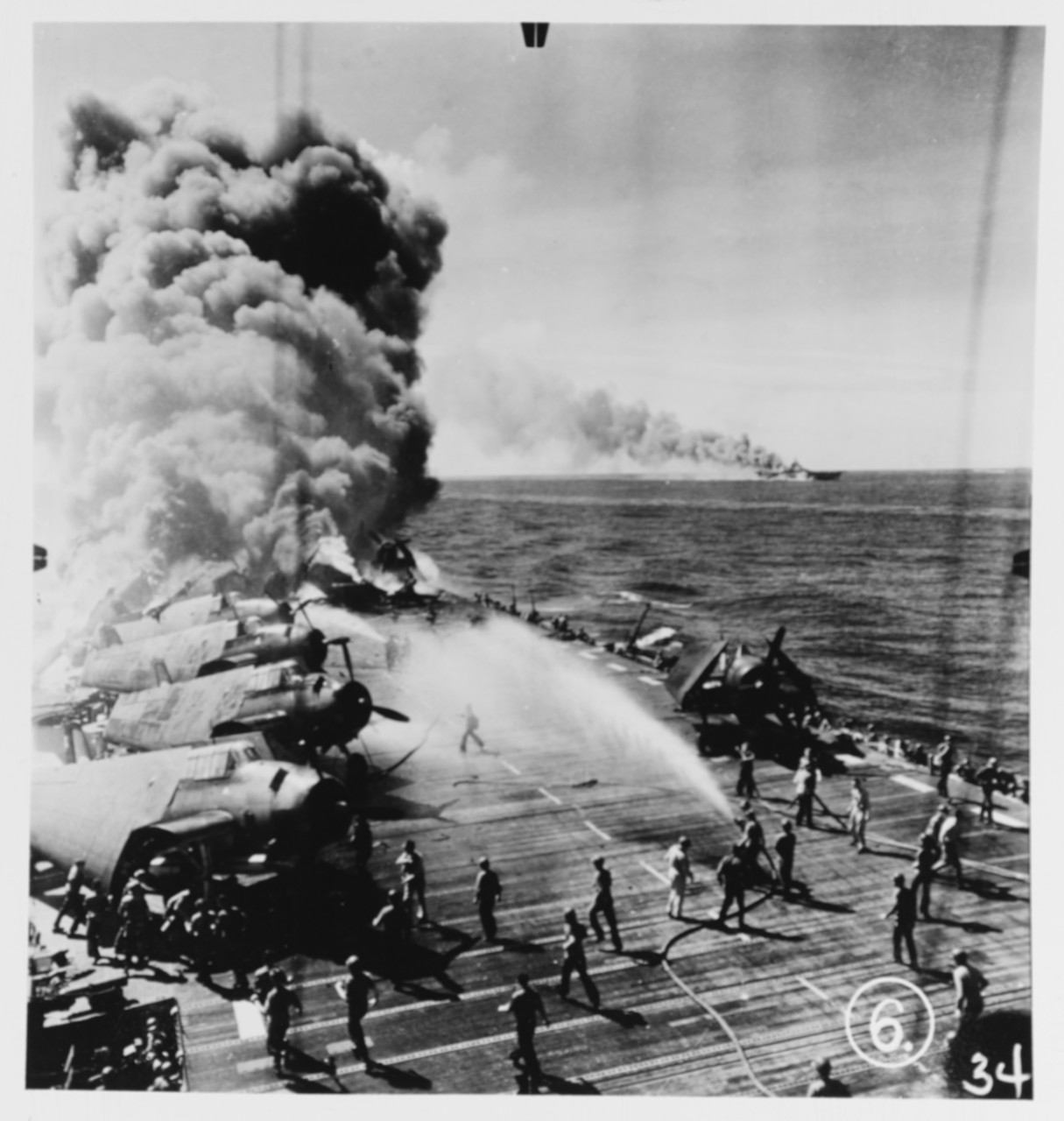 Belleau Wood (CVL-24) Burning aft after she was hit by a Kamikaze, while operating off the Philippines on 30 October 1944.