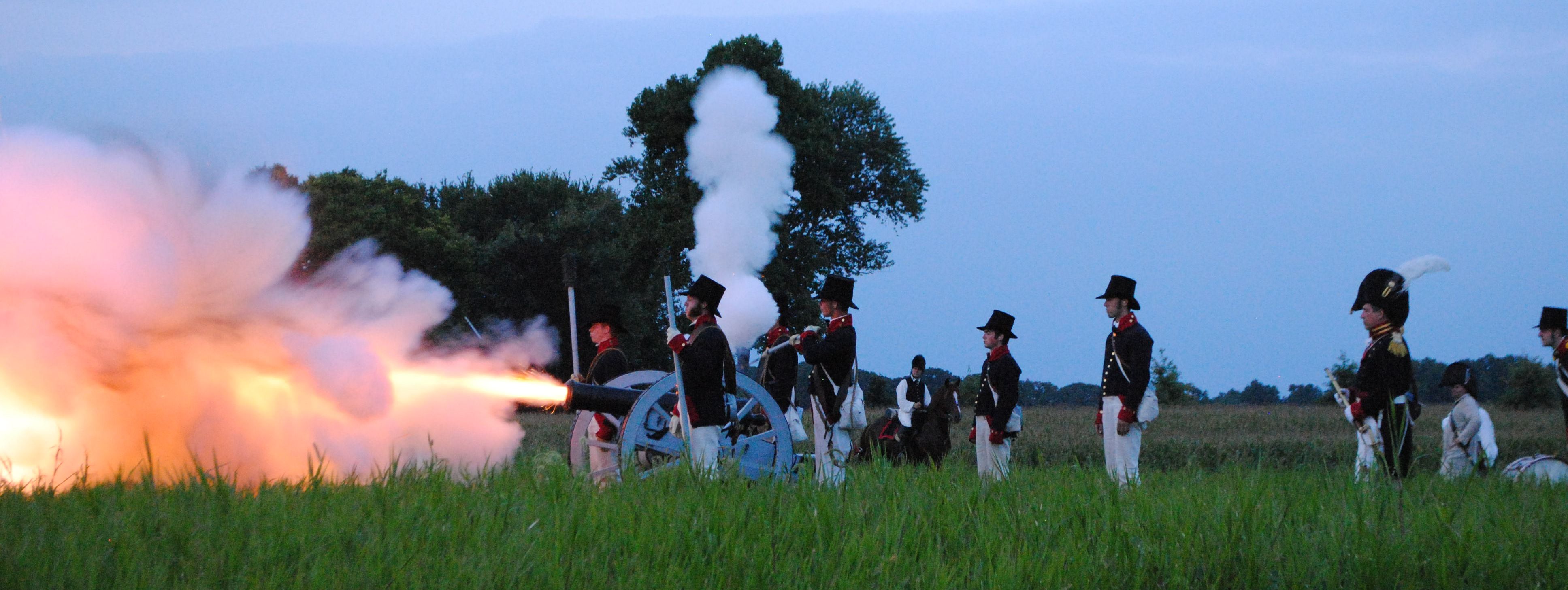 American militia reenacters fire their cannon during the ceremonies for the Bicentennial of the battle in 2024.