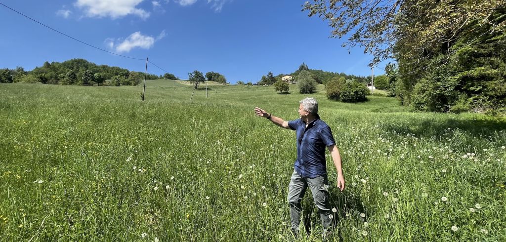 Historian Gabriele Ronchetti points up Hill 913 where a German machine gun opened fire on Lt. Bob Dole and his platoon. Over 400 Americans died in the effort to push Nazis off the hill. Photo by Edwin Grosvenor.
