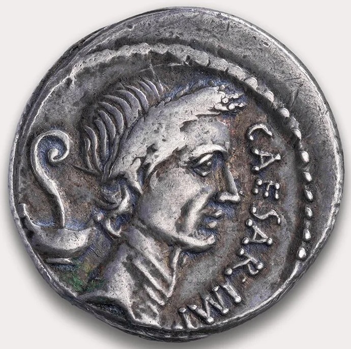 Julius Caesar appeared on a silver denarius in 44 BCE, the earliest official portrait of a specific, identifiable, and living person on a coin in the Western world was the Roman dictator Julius Caesar. He broke the strict Republican taboo against putting living humans on currency, a highly controversial political move to solidify his absolute power.