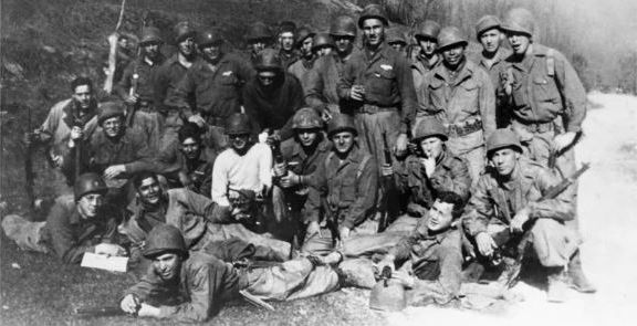 Lt. Dole in the light-colored jacket (far left) with the men of his platoon in early 1945. Dole Collection, University of Kansas.