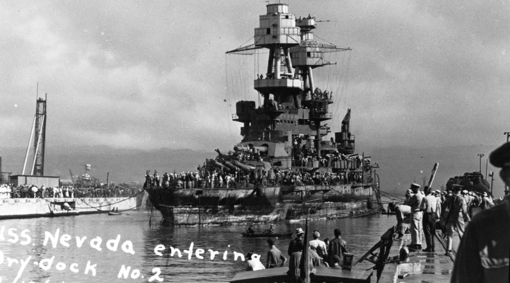 USS Nevada entered a dry dock at Pearl Harbor for temporary repairs, then steamed to Puget Sound for a modernization overhaul.