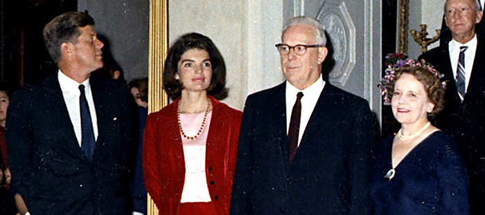 Photograph of President John F. Kennedy and his wife, Jacqueline, posing for a portrait with Chief Justice Earl Warren
