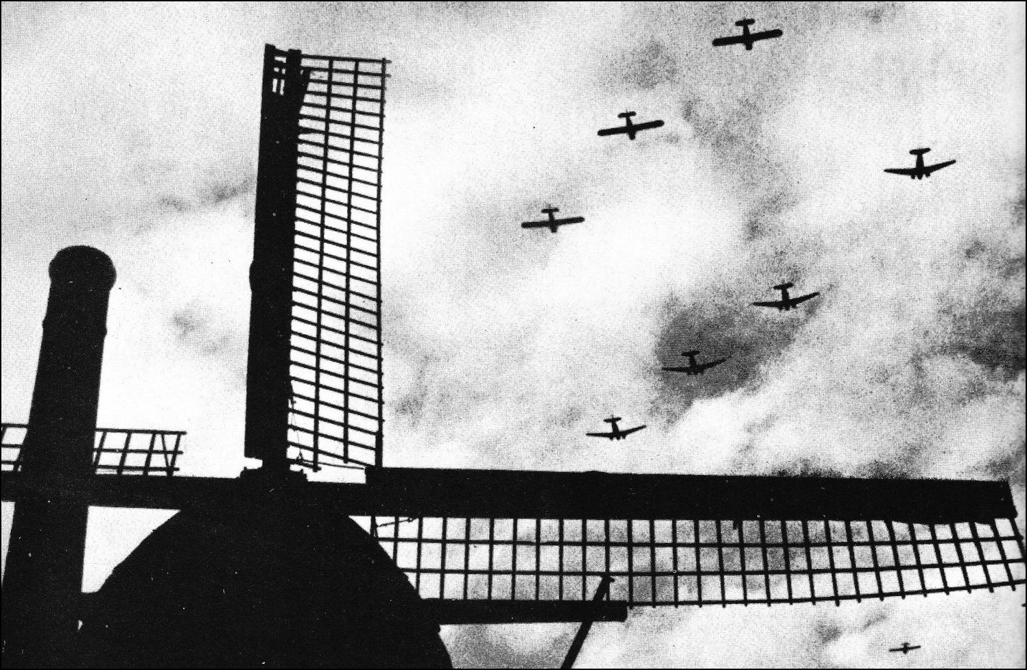 Framed by a Dutch windmill, C-47 transports tow glider-borne infantry into Operation Market-Garden. 