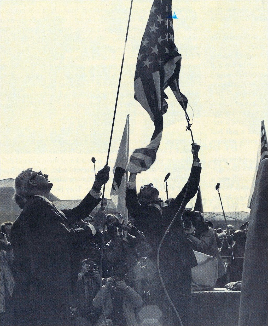 Stapleton Roy helps to untangle the old flag so a new one can rise over the embassy. Courtesy of the author.