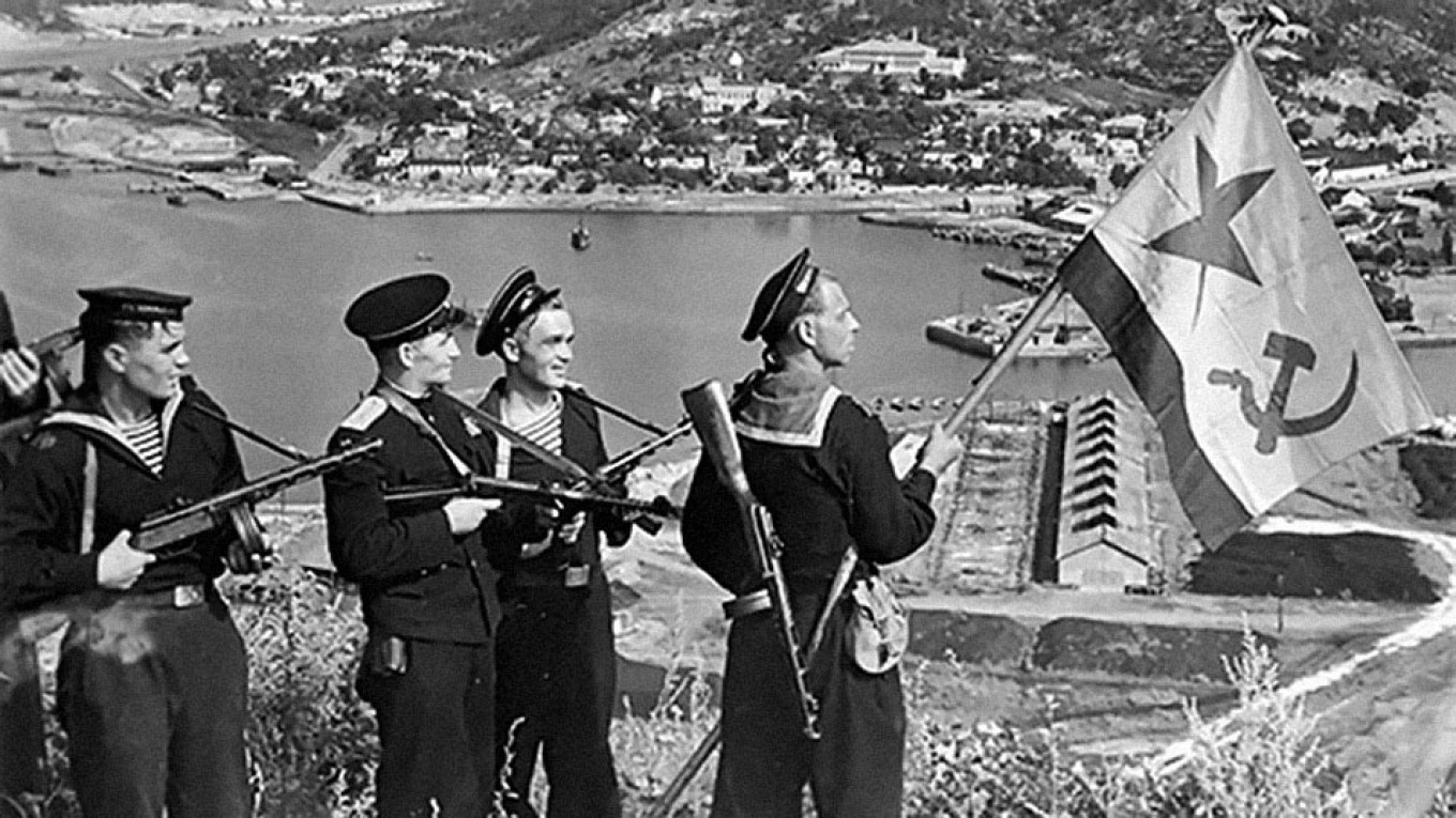 Soviet sailors wave their flag in Port Arthur after invading Manchuria in October 1945. Hundreds of thousands of Japanese nationals died in Soviet captivity. RIA Novosti