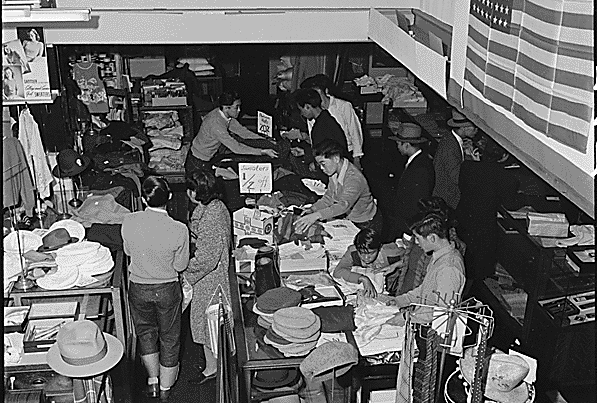 American citizens of Japanese descent on the West Coast were given short notice to prepare to leave. Merchants were forced to sell inventory at distress prices, and many never recovered their businesses. National Archives.